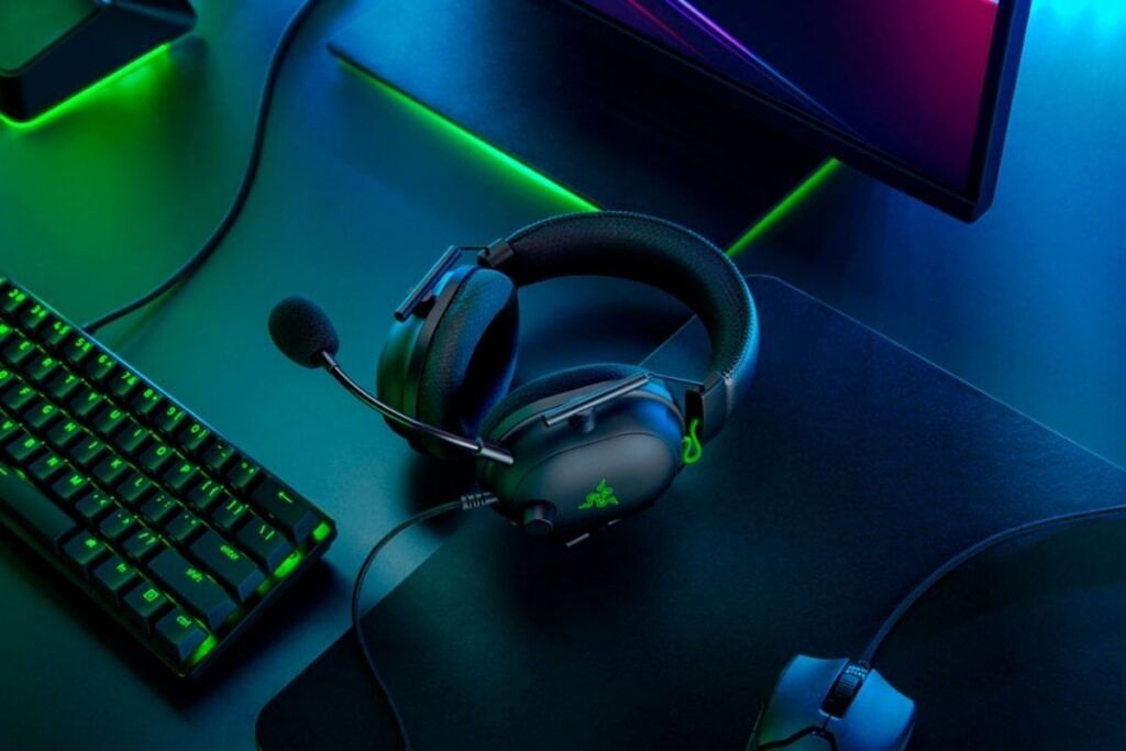 Razer Blackshark V2 wired headset kept on a table next to a keyboard and mouse